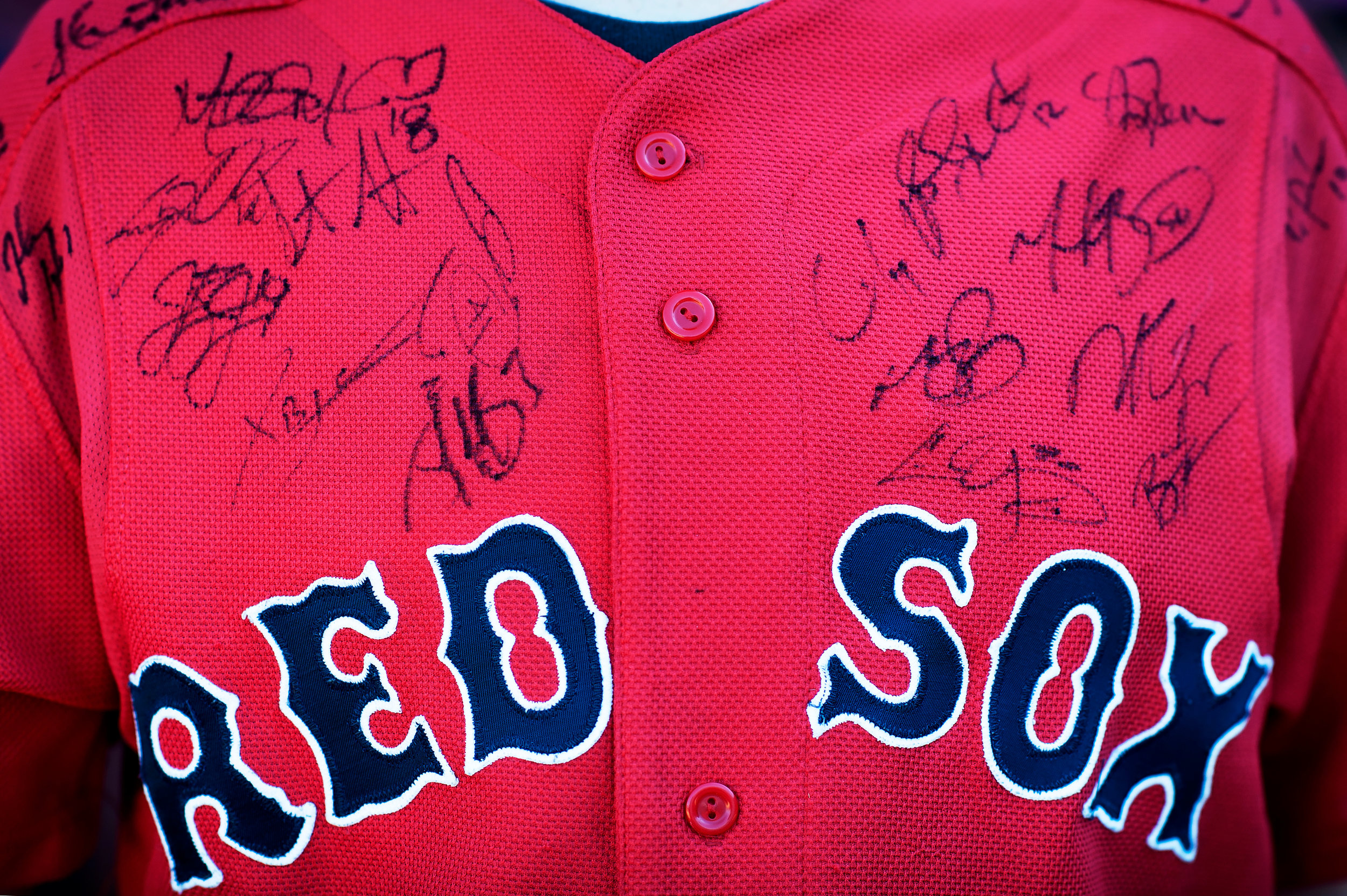  A fan wearing a Red Sox jersey with several signatures watches batting practice before the game against the Texas Rangers at Fenway Park in Boston, Massachusetts on Monday, July 9, 2018. 