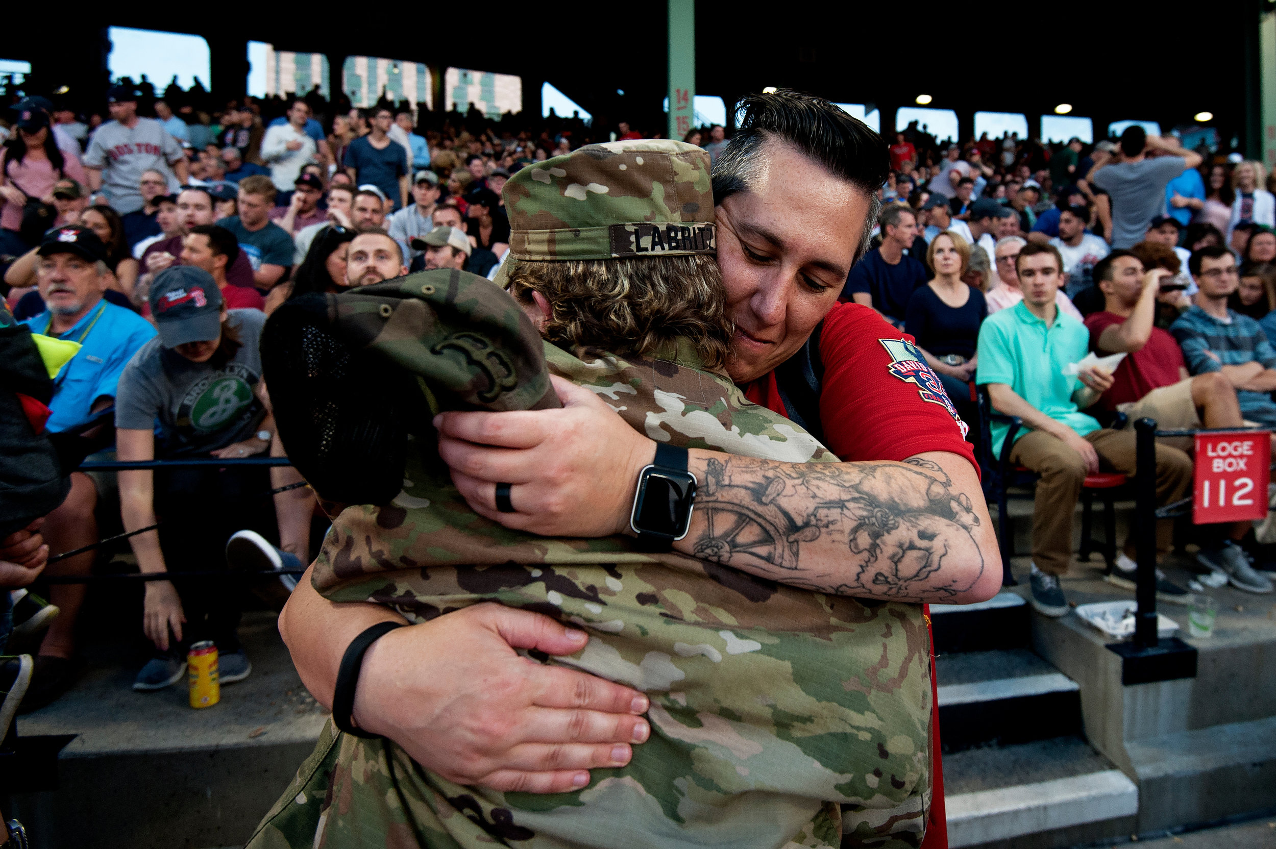  A fan hugs a servicewoman who was honored during Fenway’s Hats Off to Heroes ceremony in the fourth inning of the game against the Chicago White Sox in Boston, Massachusetts on Friday, June 8, 2018. 