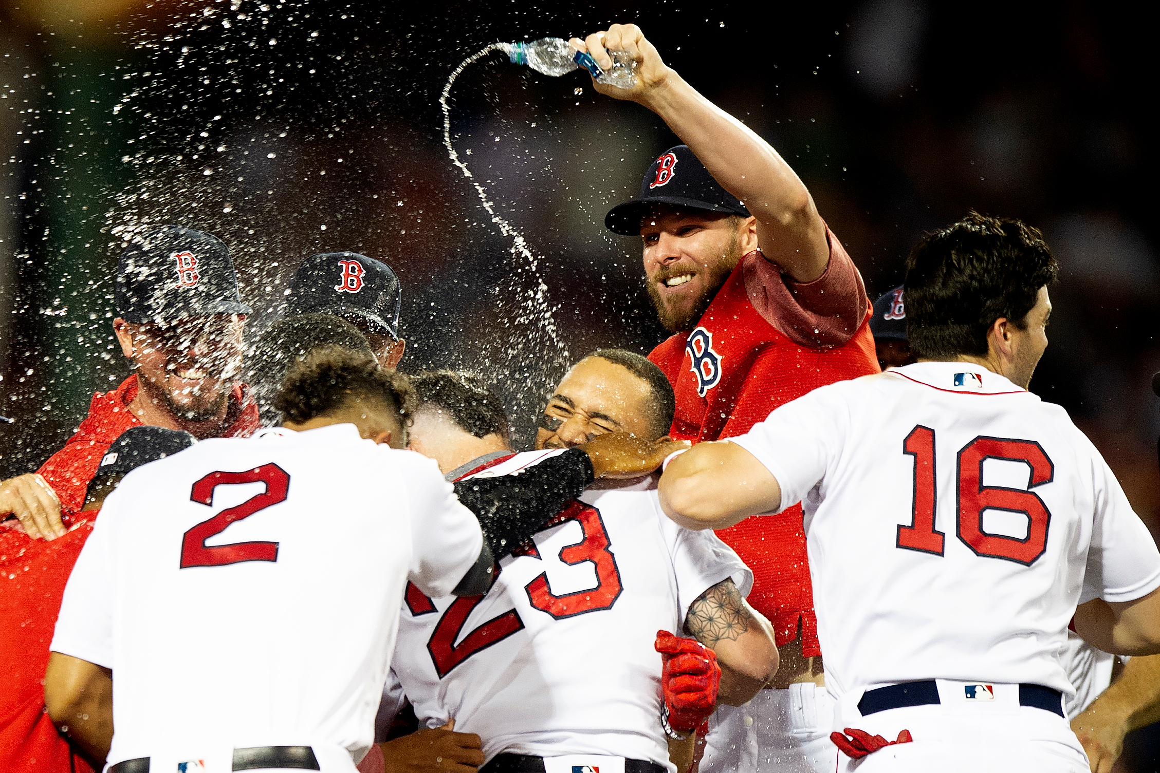  The Boston Red Sox swarm catcher Blake Swihart after he made a hit that ended the thirteen-inning game against the Philadelphia Phillies at Fenway Park in Boston, Massachusetts on Monday, July 30, 2018. 