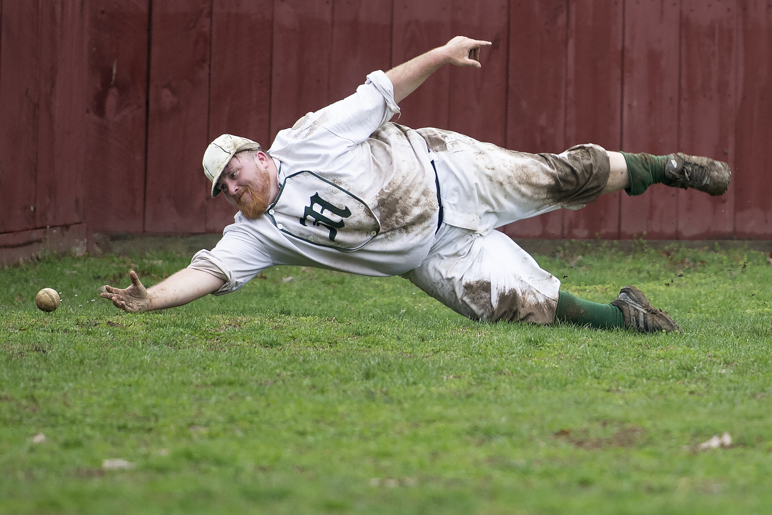  John Kreppel of the New York Mutuals attempts a diving catch at home plate during the game against the Brooklyn Atlantics at Old Bethpage Village Restoration on April 13, 2019 in Old Bethpage, NY. In 1864, players did not use baseball gloves and ins