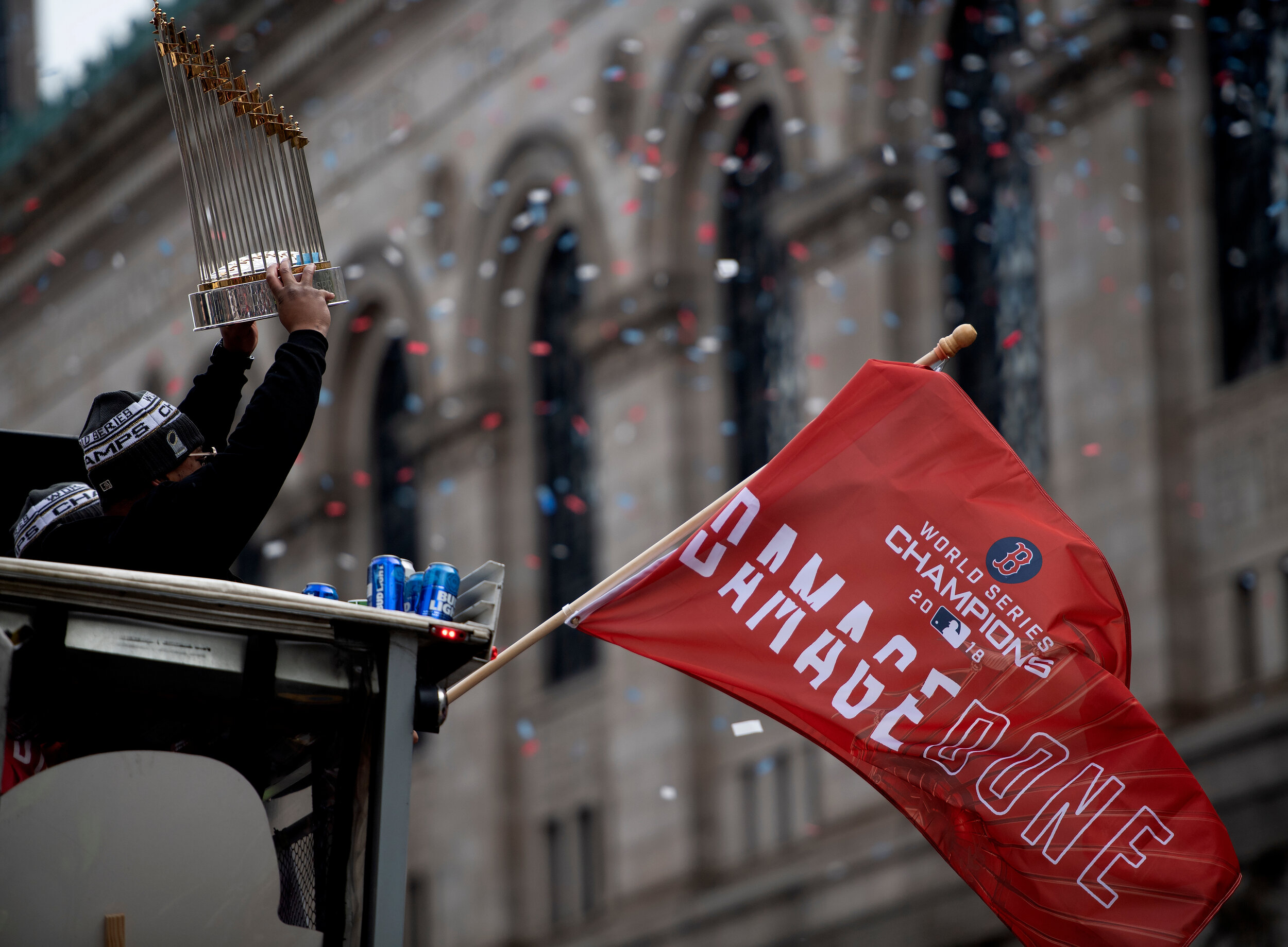  Rafael Devers #11 holds the Commissioner’s Trophy as confetti fills the air during the Boston Red Sox’s World Series parade through downtown Boston, Massachusetts, on October 31, 2018. 