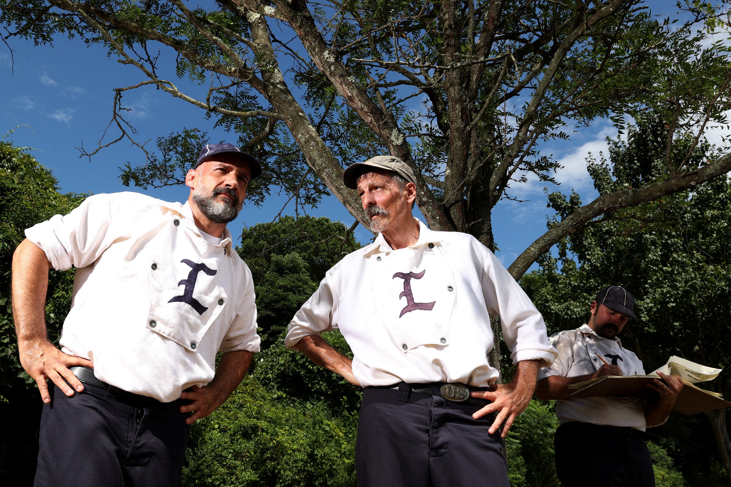  Members of the New Jersey Liberty watch their team's game during the 25th Annual Doc Adams Old Time Base Ball Festival at Old Bethpage Village Restoration on August 07, 2022 in Old Bethpage, New York. 