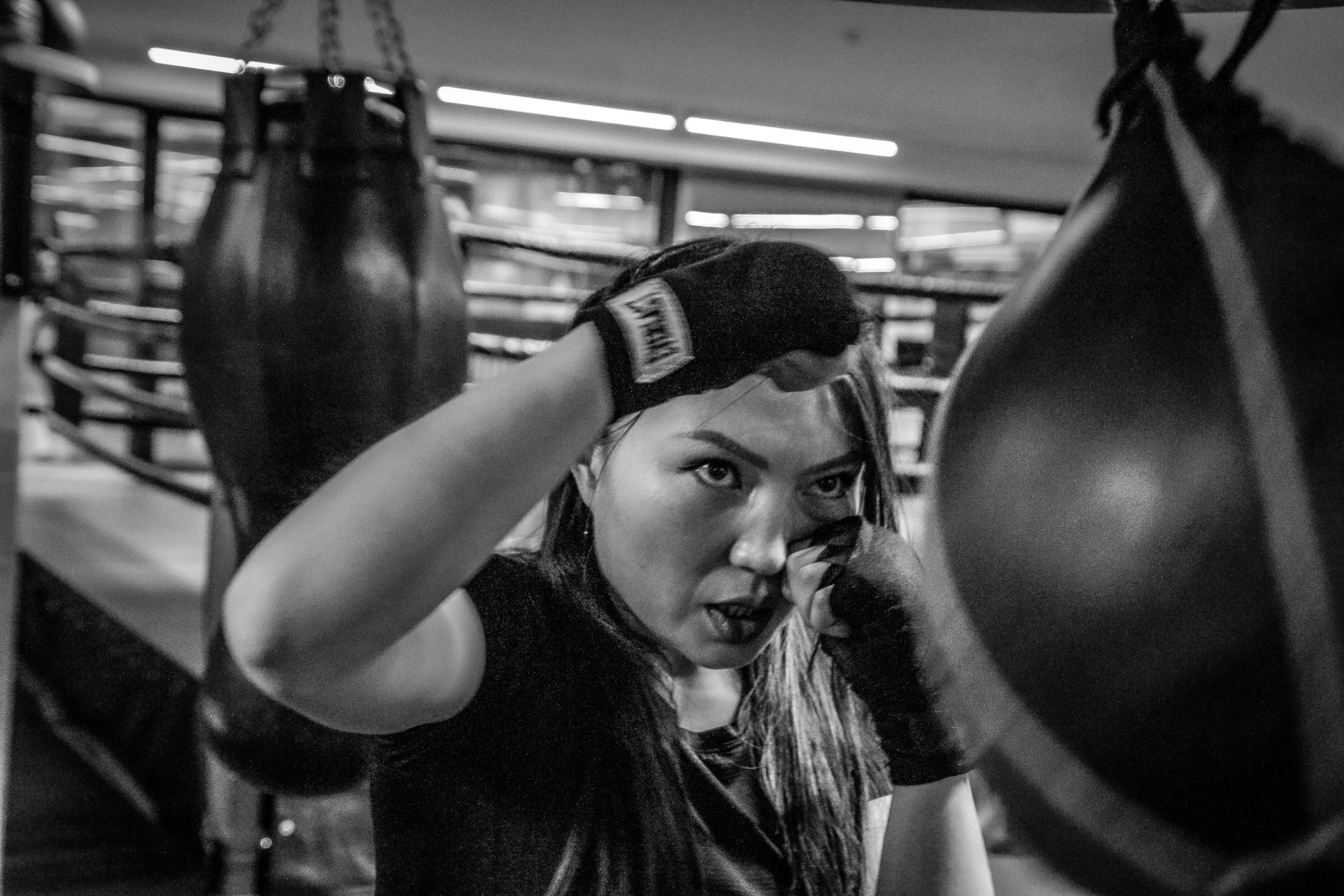 a woman preparing to hit a speed bag