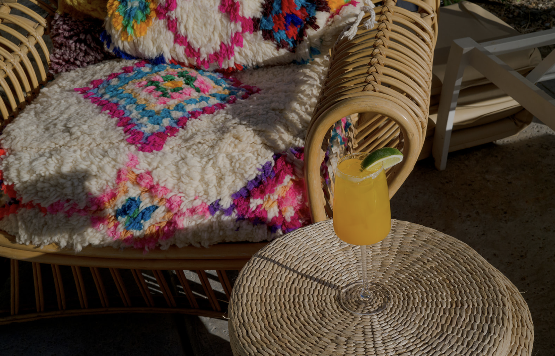Wicker lounge chair, pillows and rental styling