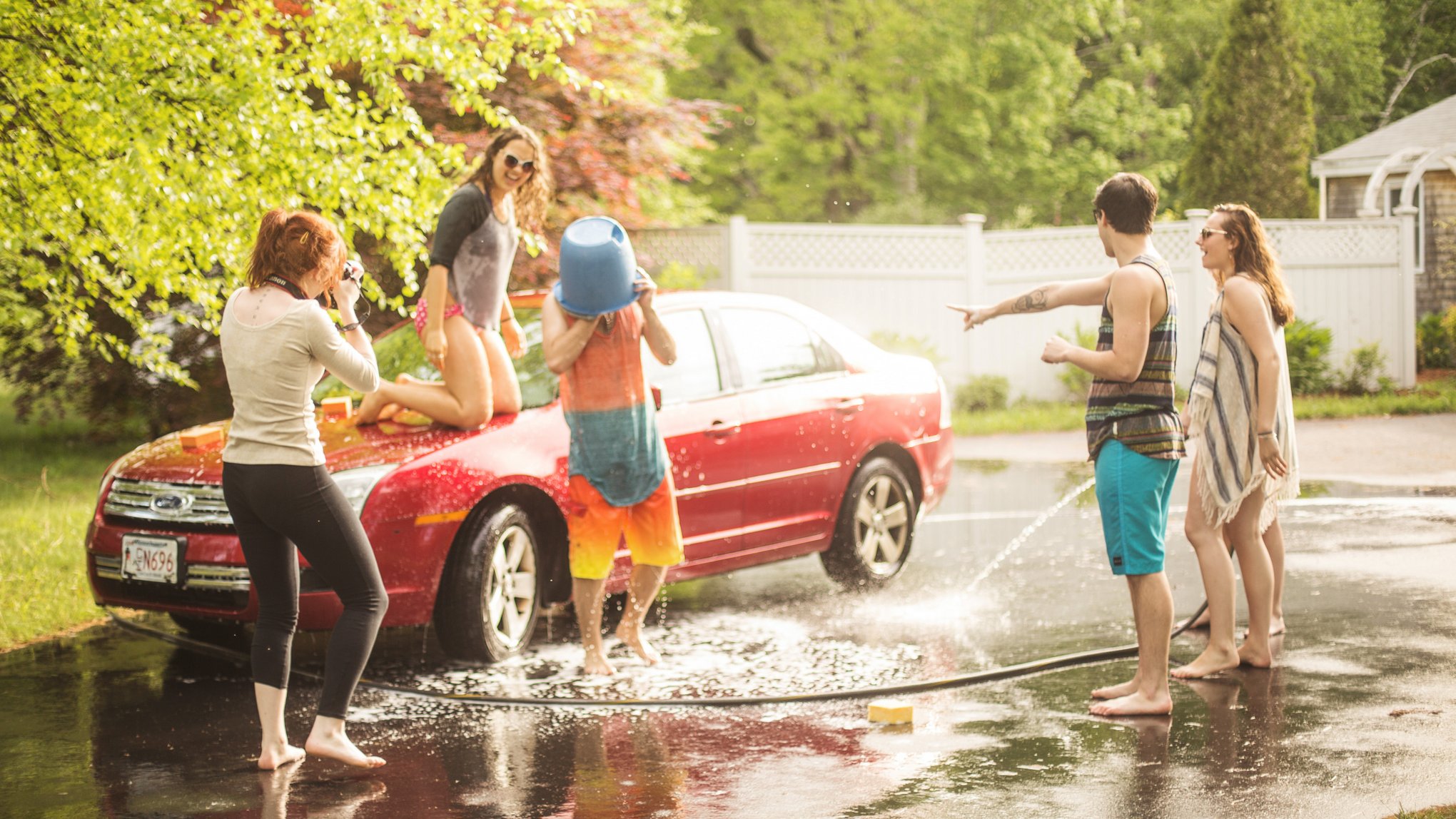Behind the scenes on a car wash stock shoot (in Barb's driveway!) - Props to anyone that recognizes my second shooter on top of the car, Jenny!