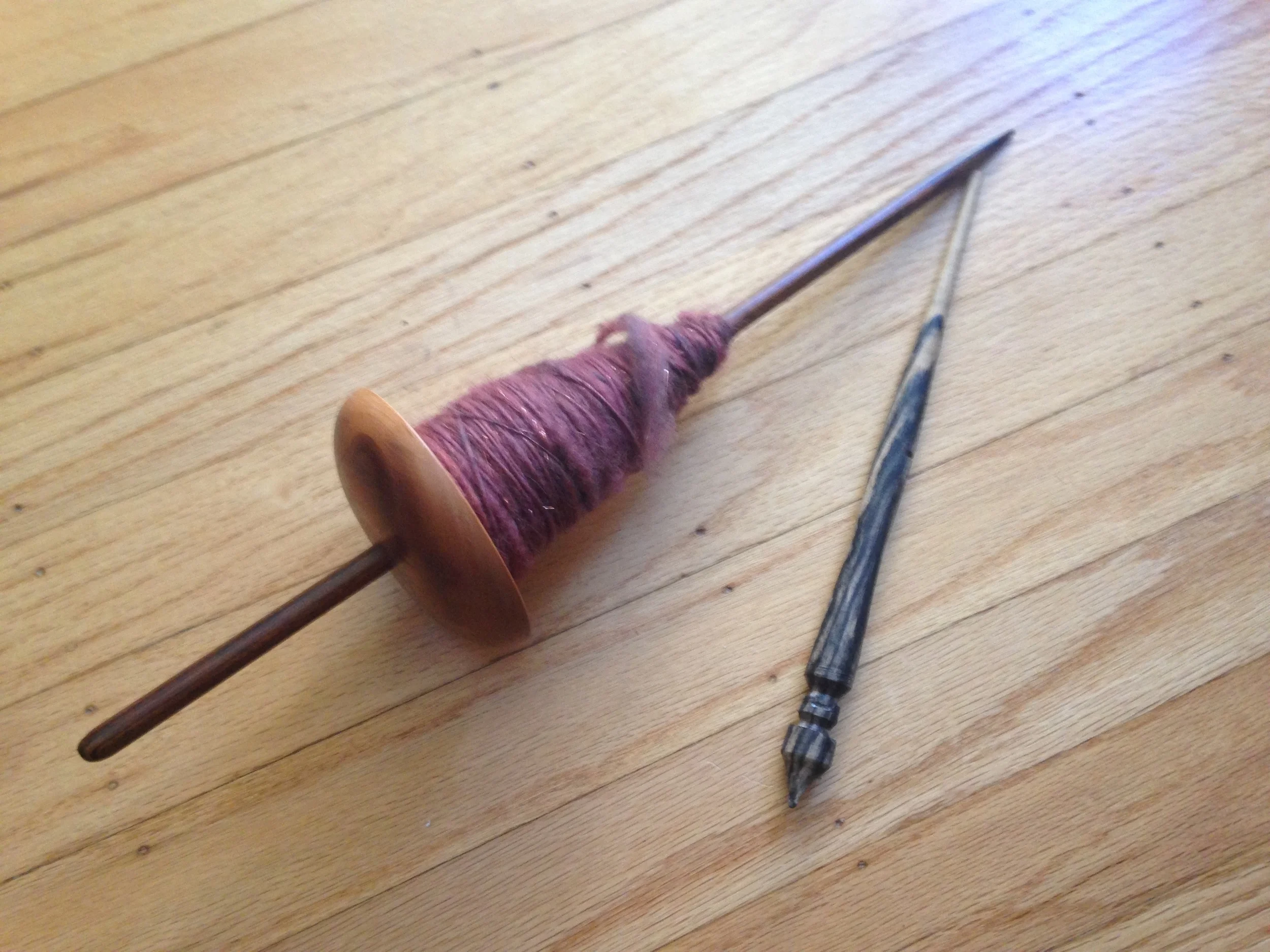 Supported spindle and Navajo spindle (with the cop of fiber).