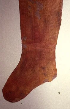 Red silk stocking buried with Eleanor de Toledo.