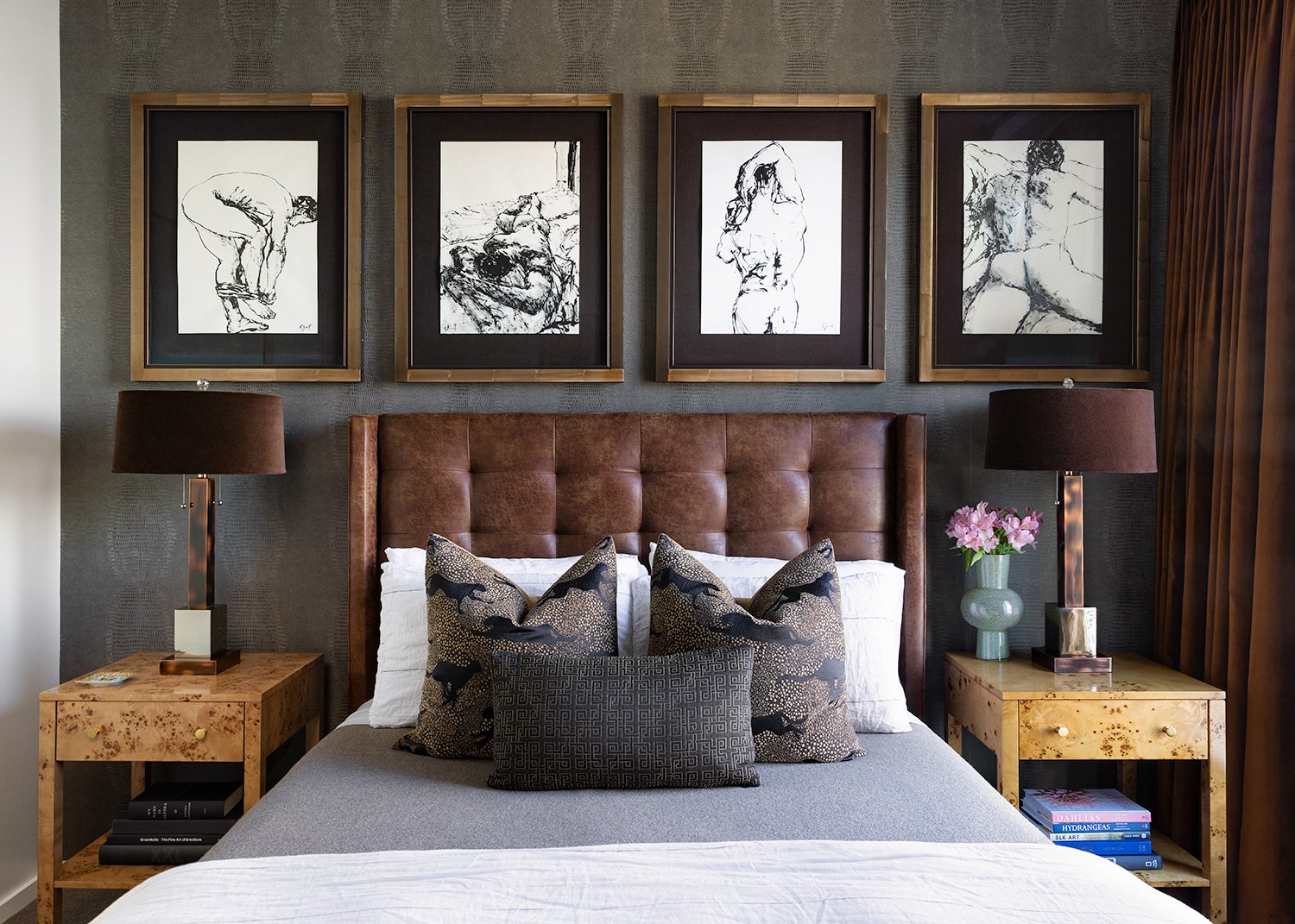 Editorial interior design photography of a luxury primary bedroom with a tufted leather headboard and curated gallery wall. Photographed by Phillip Istomin for Curious Homes.
