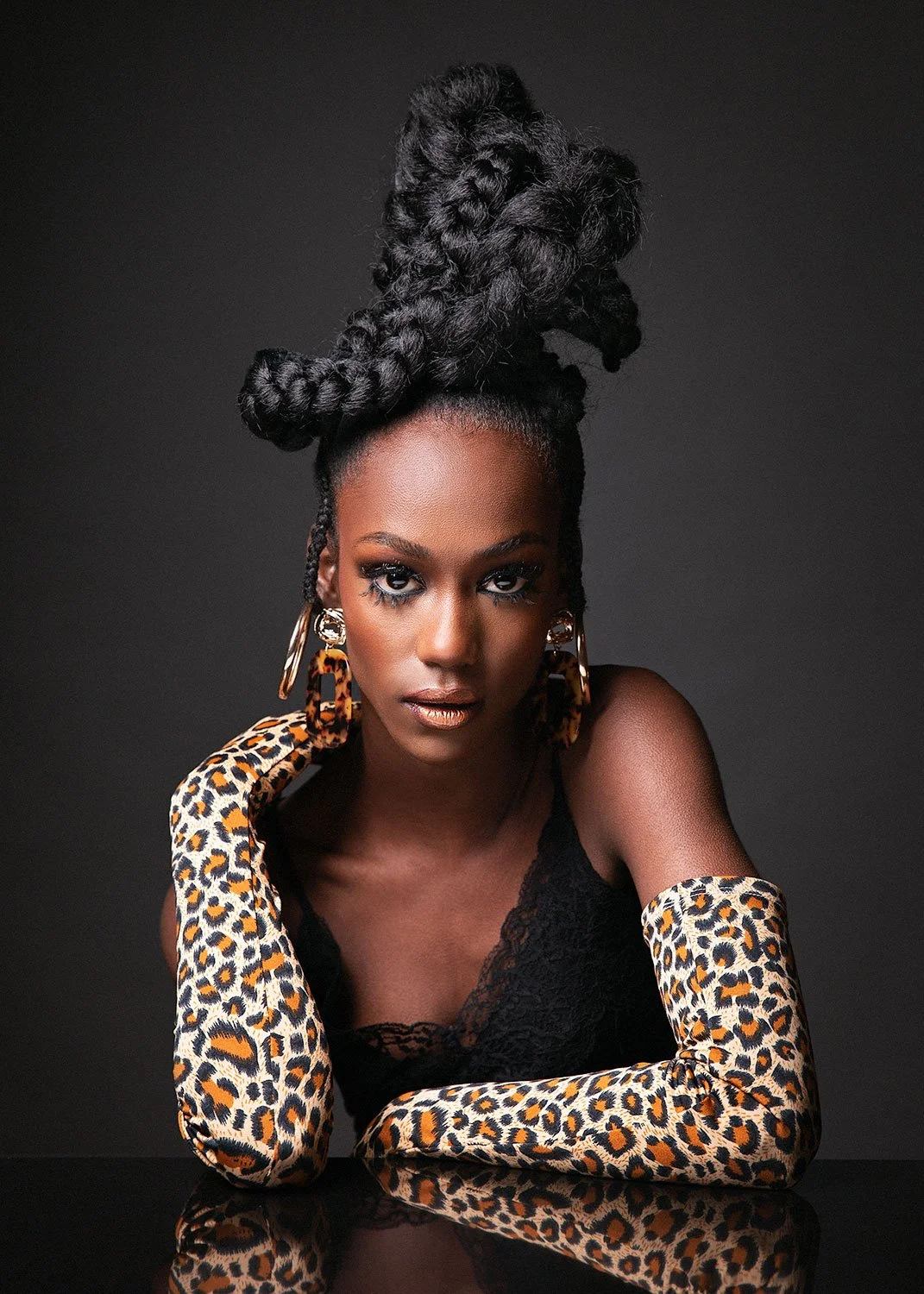  Bold editorial fashion portrait by MANICPROJECT featuring high-contrast studio lighting, leopard print gloves, and sophisticated styling in Salt Lake City 