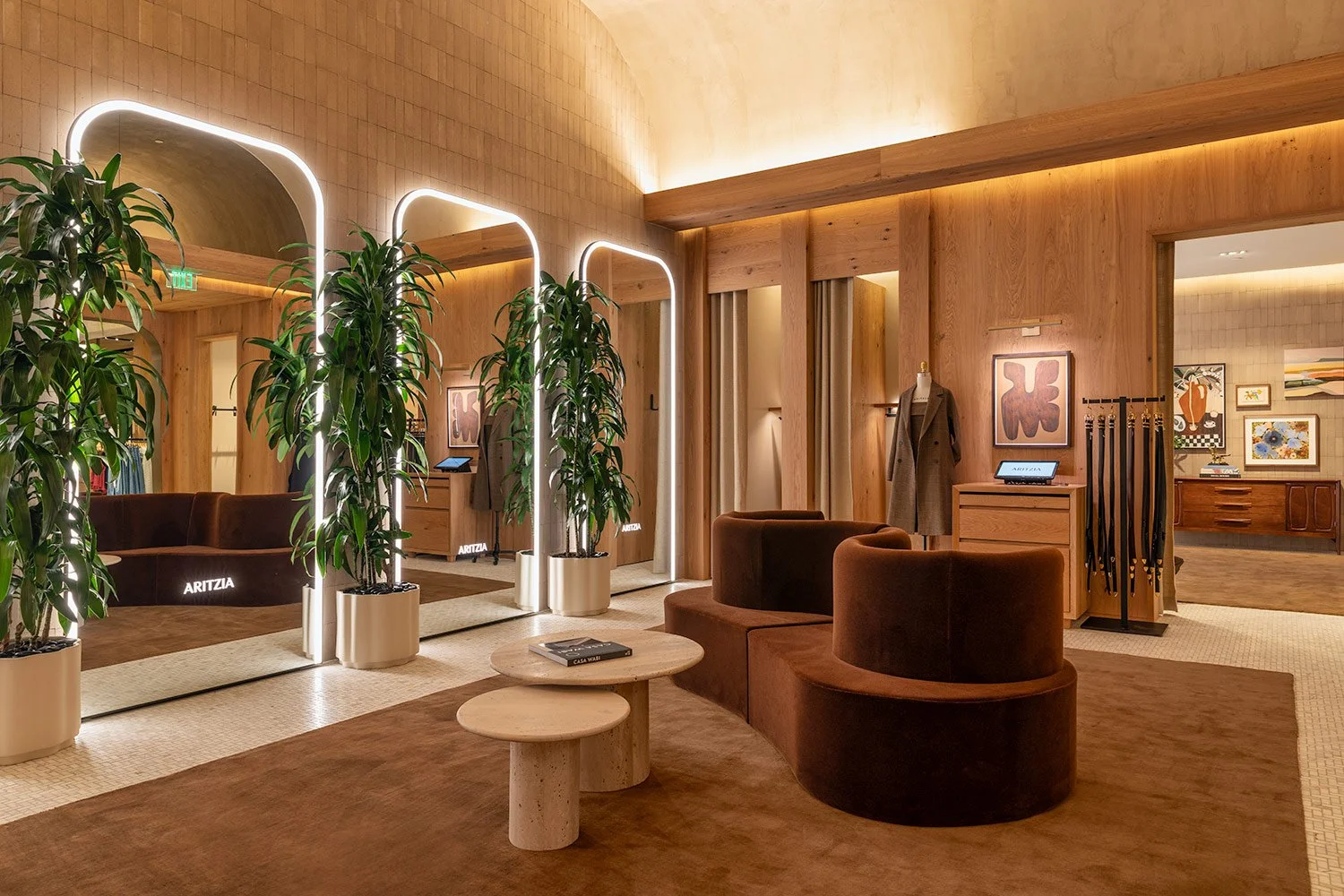  Commercial interior photography of the fitting room lounge at the Aritzia boutique, showcasing sophisticated architectural lighting, clean sightlines, and elevated retail design 