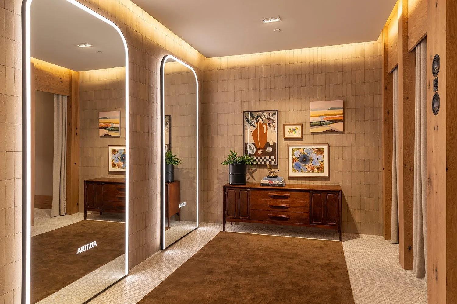  Commercial interior photography highlighting custom illuminated mirrors and bespoke interior detailing within the Aritzia retail boutique, emphasizing upscale shopping experiences 