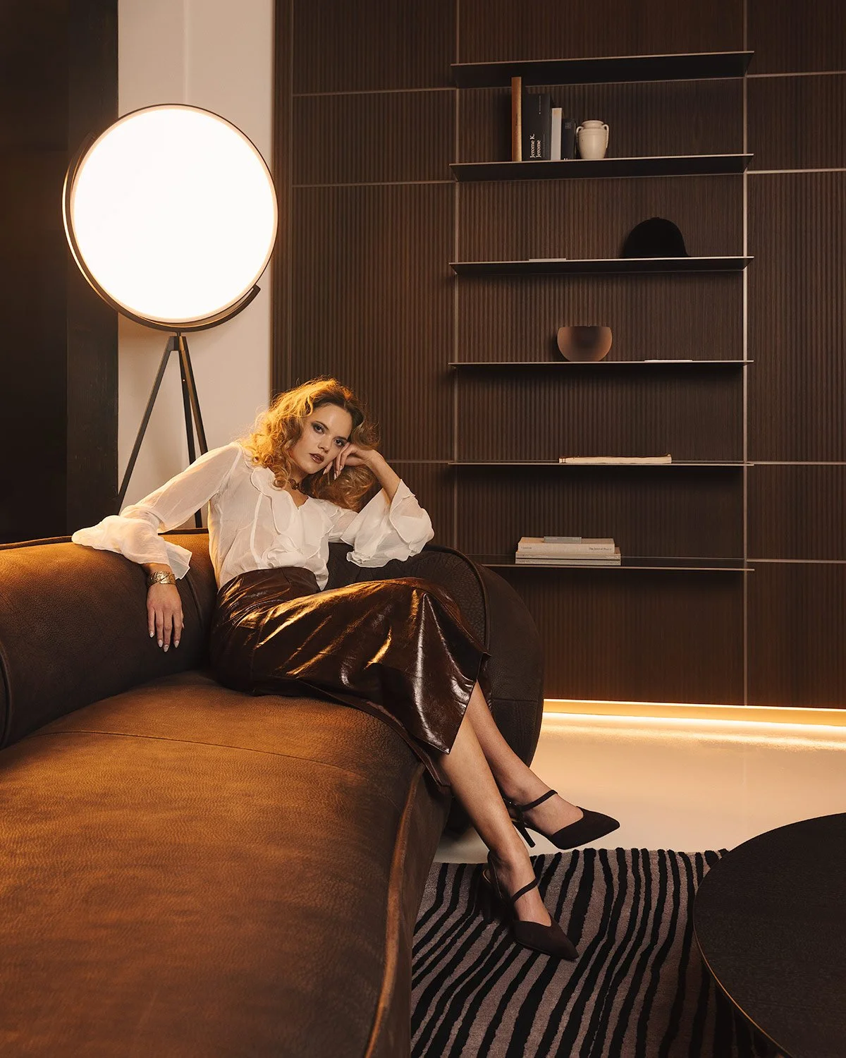  Editorial interior photography capturing a sophisticated lounge setting featuring a modern floor lamp, warm ambient illumination, and curated architectural textures designed for high-end residential portfolios 