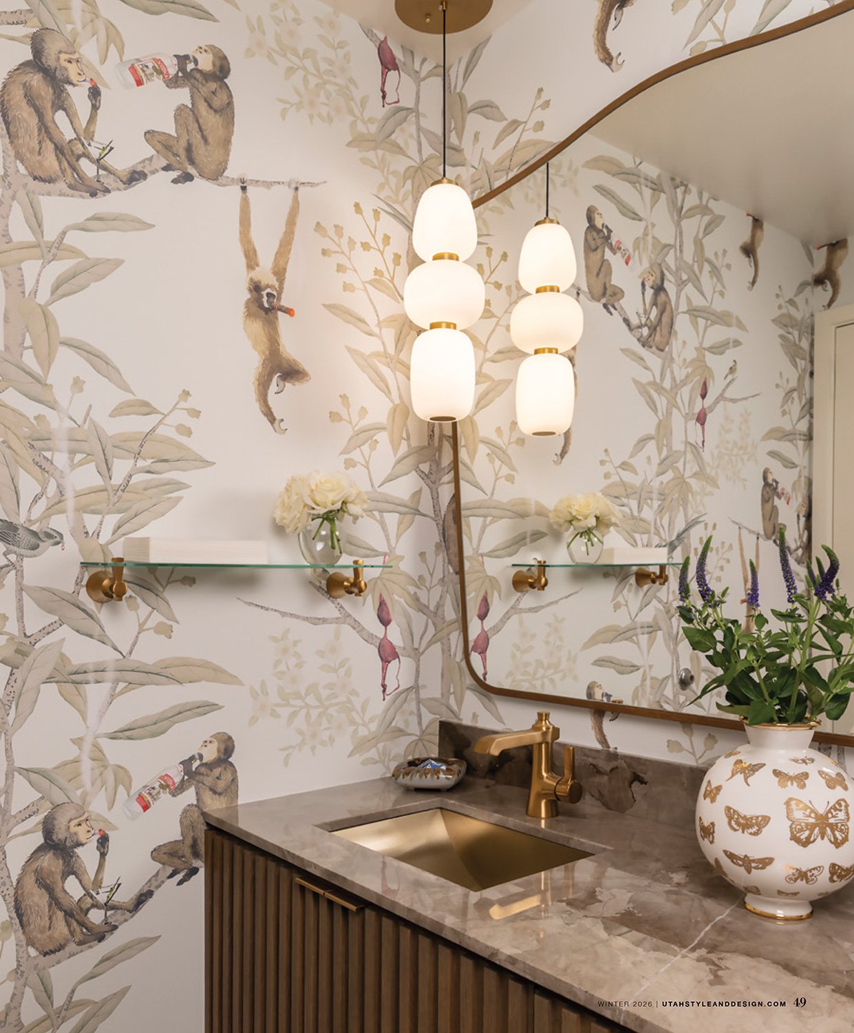 Luxury bathroom with monkey-themed wallpaper and modern pendant lighting featured in Utah Style & Design.