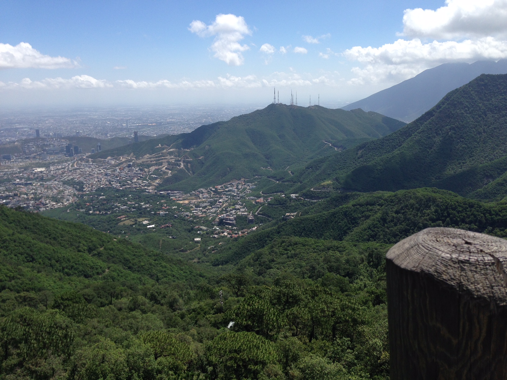 View from Chipinque at Monterrey Mexico, looking toward Guadalupe's former steel plant the largest of its kind when built in 1968, "Corruption Tower," one of Monterrey's most beautiful new government buildings, and outside the photo, half a mountain mined for its concrete. A frightening sight.