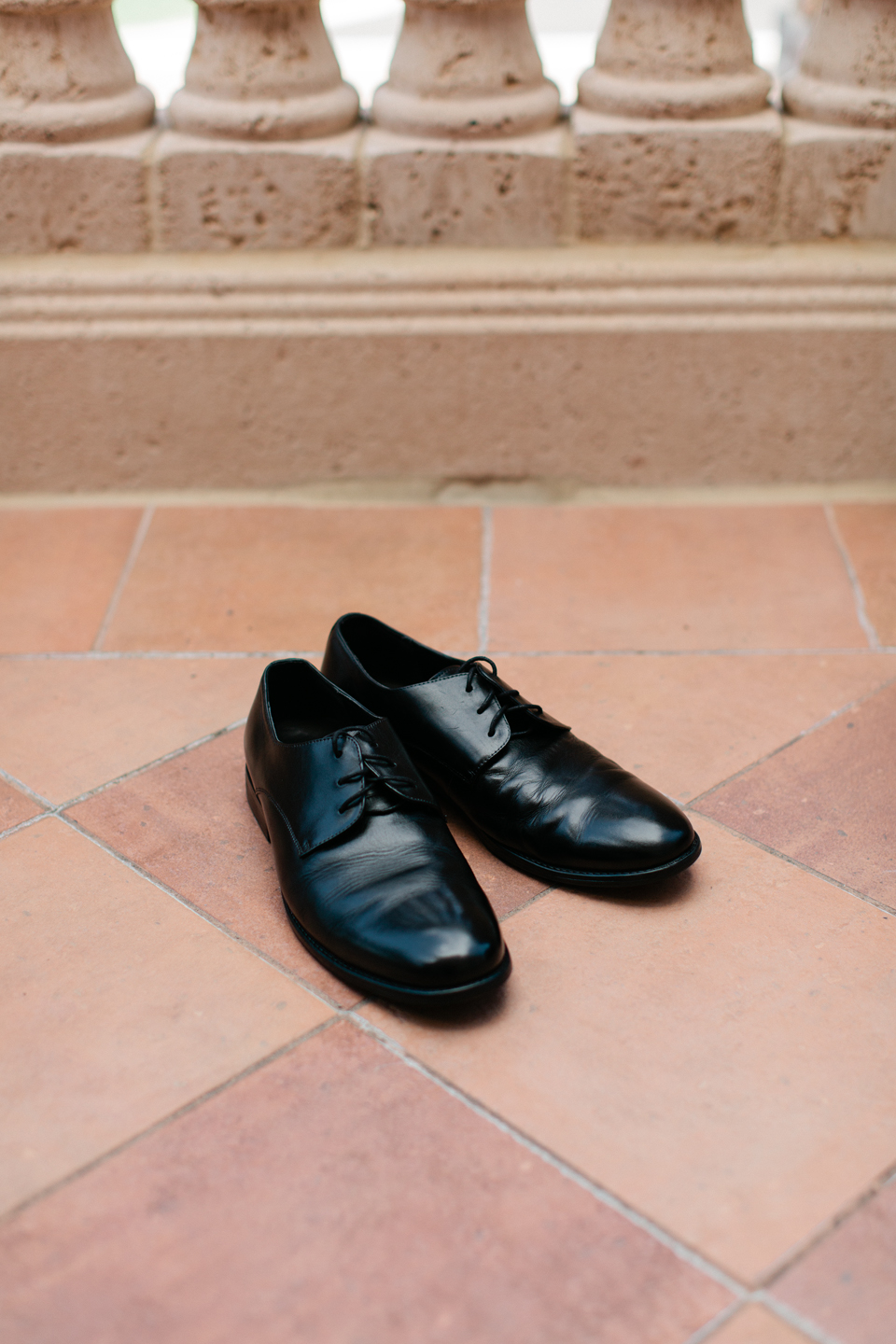 Image of men's dress shoes in black on terracotta tile at the TPC Sawgrass in Ponte Vedra, Florida