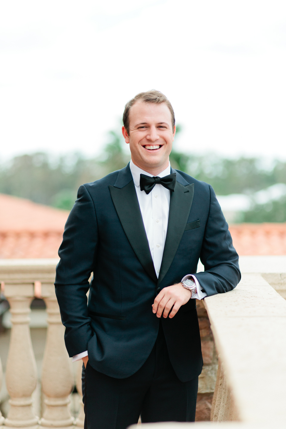 Image of a groom in a black tuxedo on the second floor of the TPC Sawgrass in Ponte Vedra, Florida