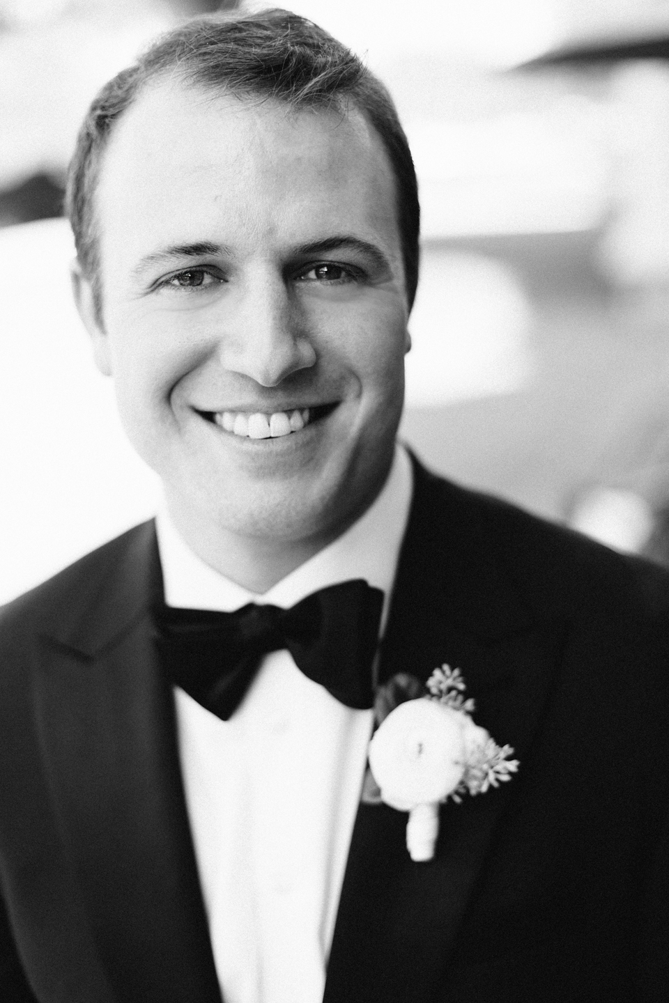Image of a groom in a black tuxedo on this wedding day.  The groom is at the TPC Sawgrass in Ponte Vedra, Florida