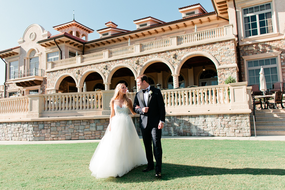 Image of a bride and groom walking arm in arm on their wedding day at the TPC Sawgrass in Ponte Vedra, Florida