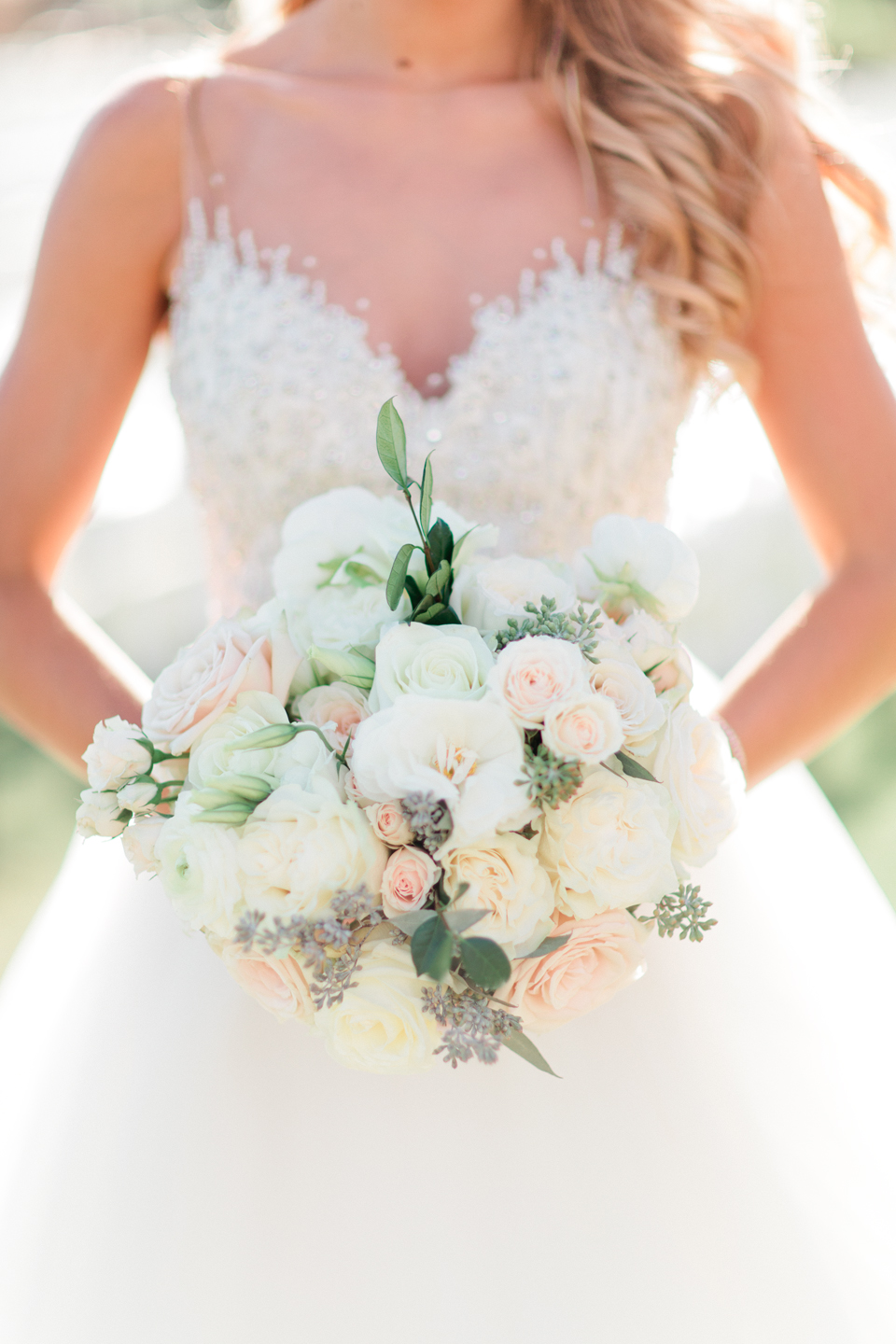 Image of a bride holding her bridal bouquet with white blossoms at TPC Sawgrass in Ponte Vedra, Florida