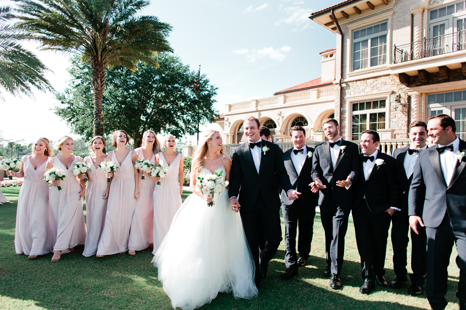 Image of the bridal party walking on the wedding day at TPC Sawgrass in Ponte Vedra, Florida