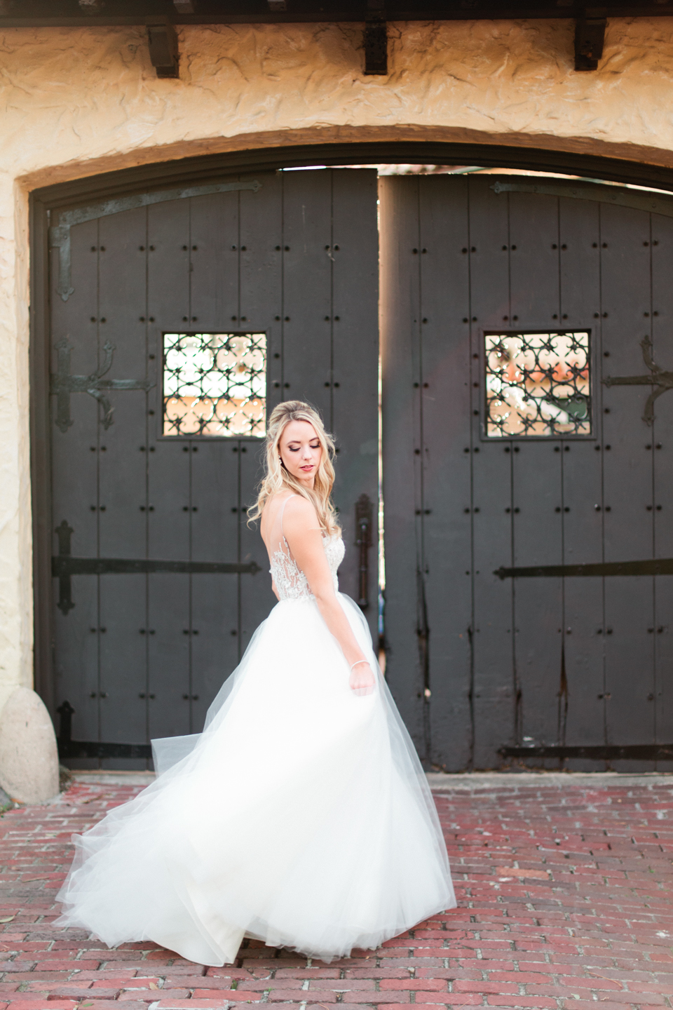 Picture of a bride in a Calvet Couture wedding gown in front of two large wooden doors at the Epping Forest Yacht Club in Jacksonville Florida