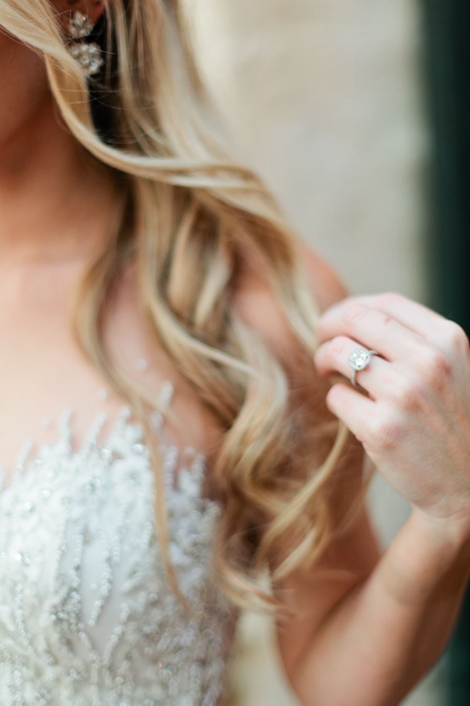 Picture of a close up of a bride and her wedding ring with her long curls.  The bride is at the Epping Forest Yacht Club in Jacksonville, Florida