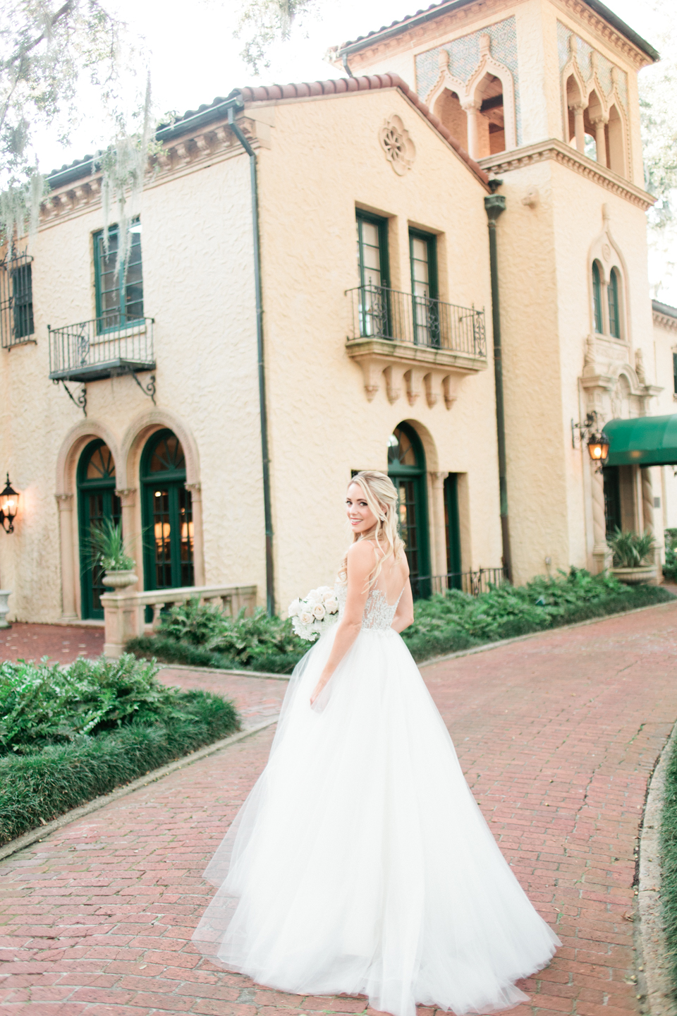 Image of a bride in a wedding gown in front of Epping Forest Yacht Club in Jacksonville, Florida.