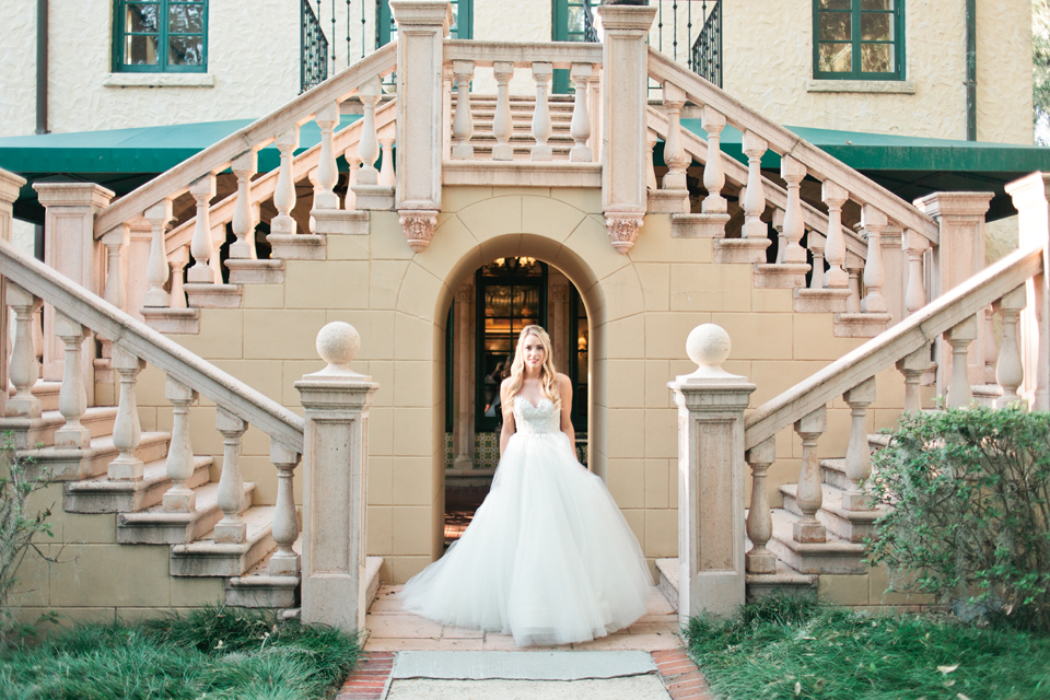 Image of a bride in a Calvet Couture wedding gown in front of the Epping Forest Yacht Club in Jacksonville, Florida 