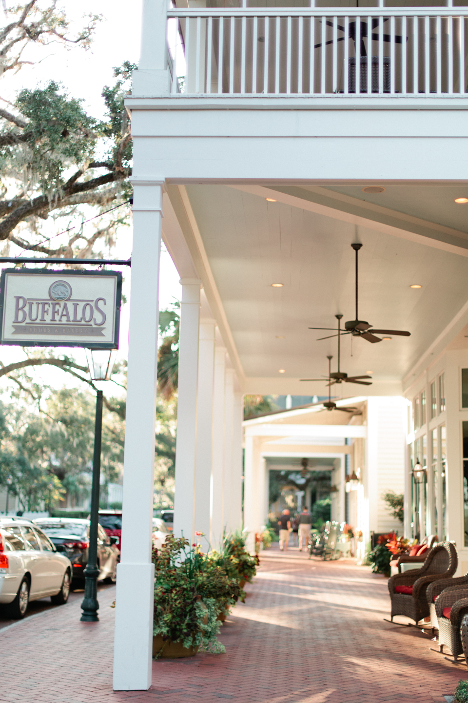 Image of a restaurant in Montage Palmetto Bluff in coastal South Carolina.  There are rocking chairs on the front porch and a sign that says, "Buffalo's".