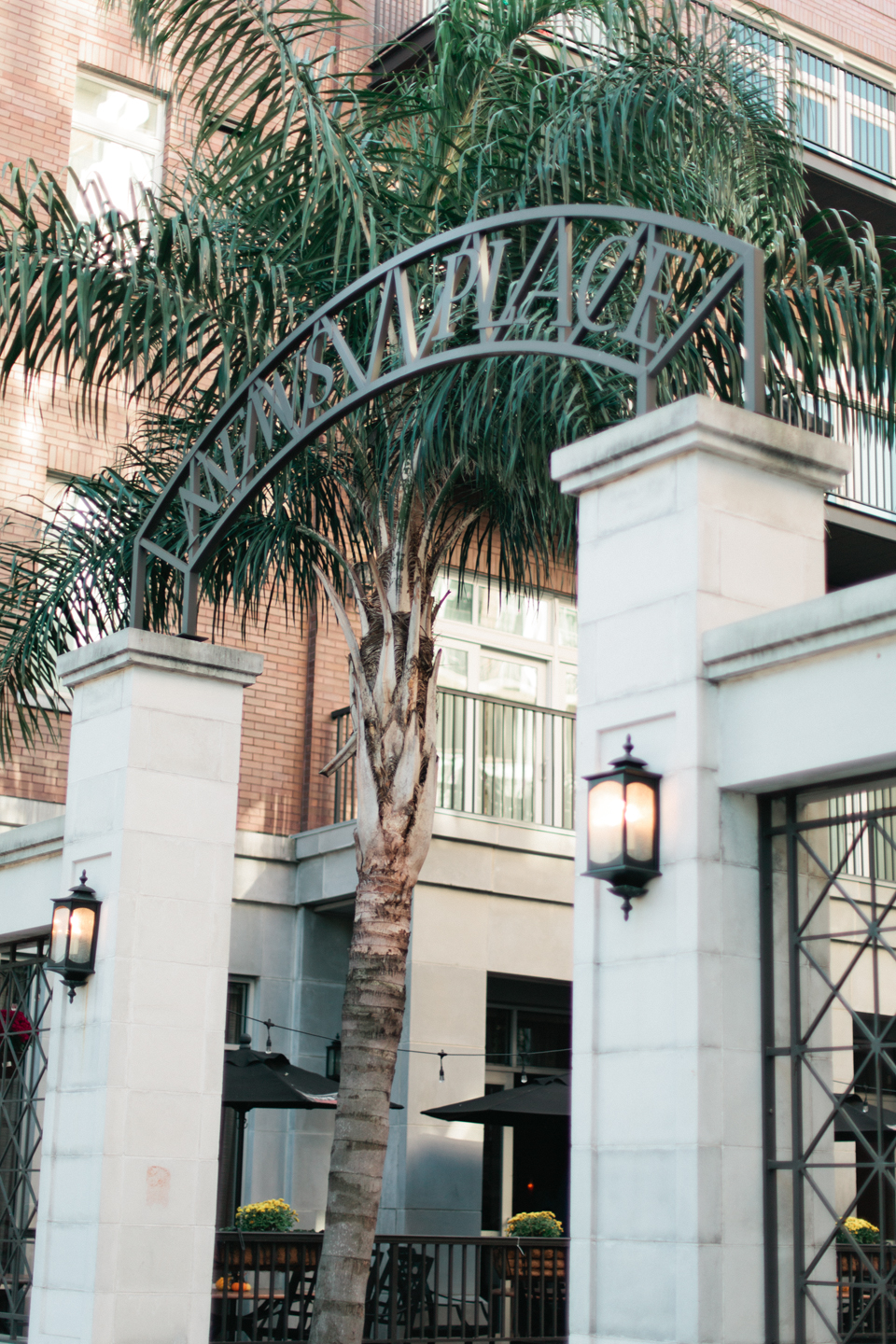 Image of historic downtown Savannah, Georgia.  Entry to a residence with two white block pillars and an iron sign.