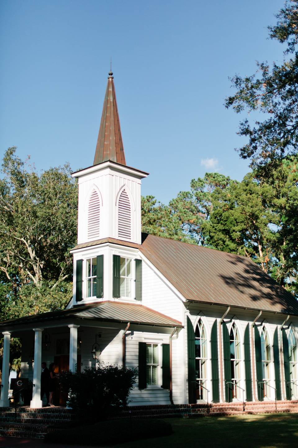 Image of a quaint white chapel with shutters in Montage Palmetto Bluff, coastal South Carolina