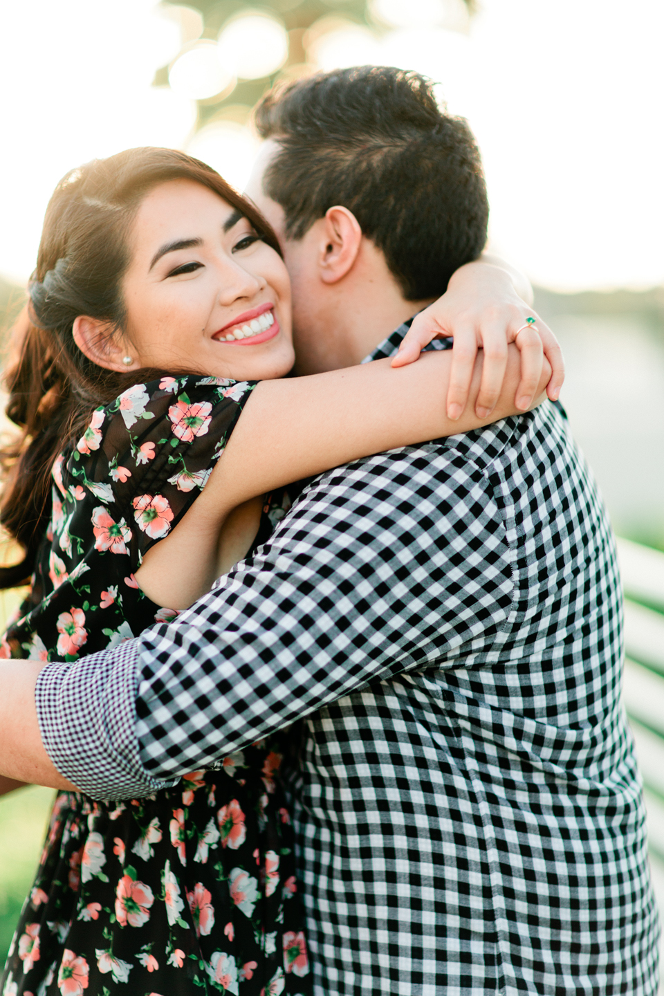 Image of a woman hugging her fiance at Curtis Hixon Waterfront Park in downtown Tampa.  This is an engagement portrait.