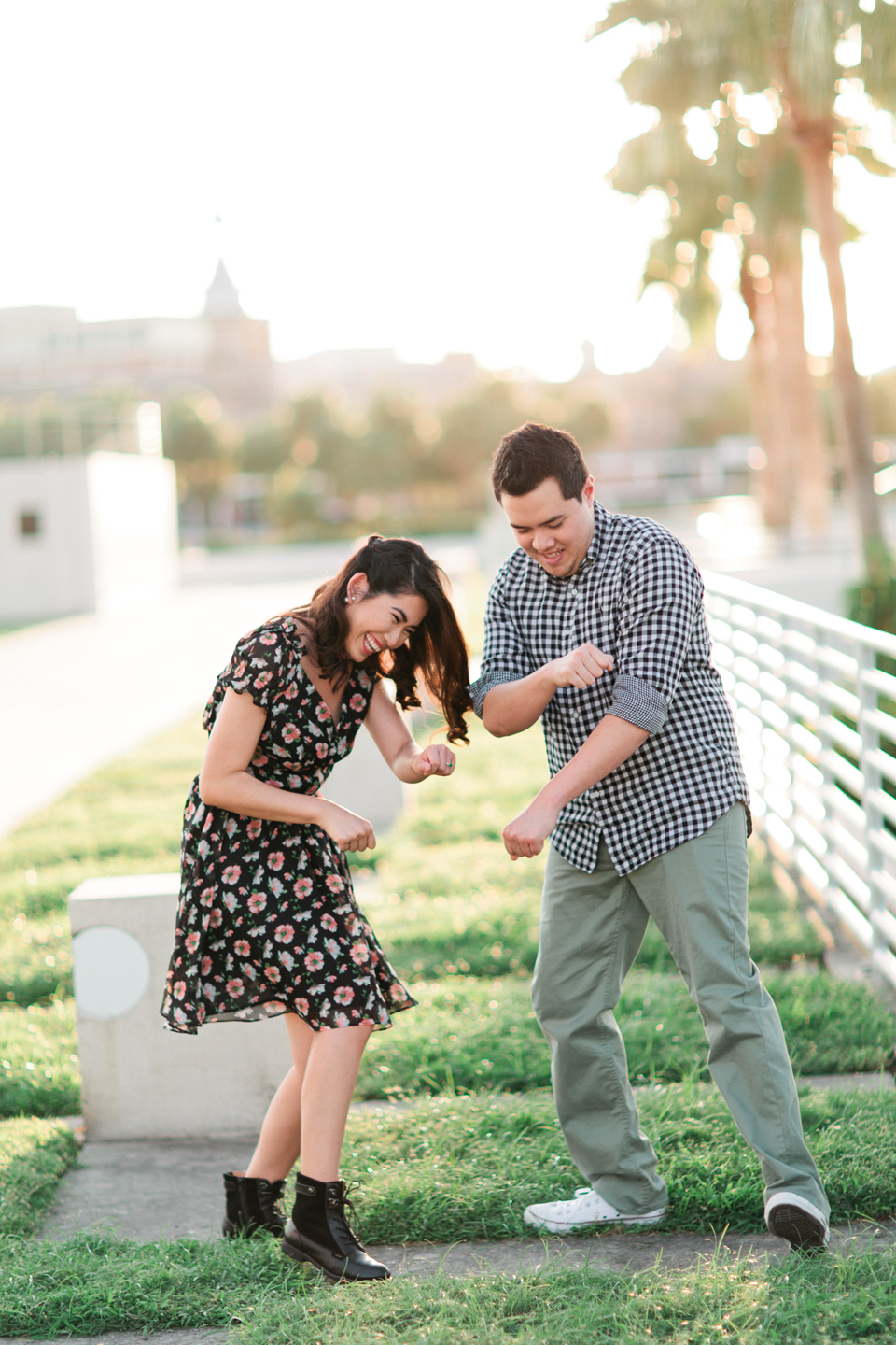 Picture of a cute couple dancing at Curtis Hixon Waterfront Park in downtown Tampa, Florida.  This is an engagement portrait.