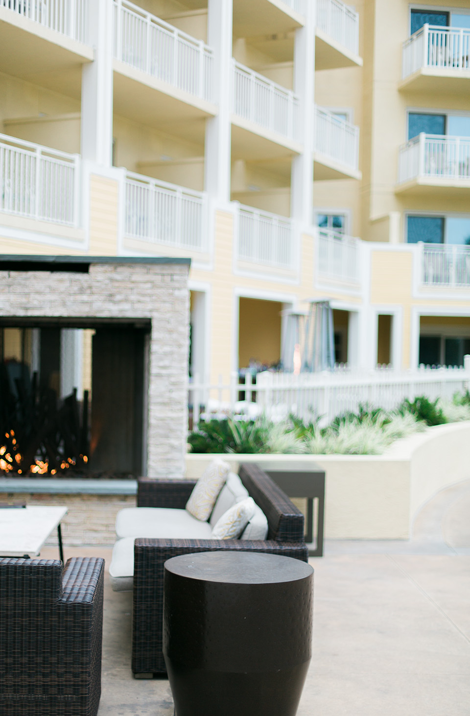 Image of one of the outdoor lounge areas at the Omni Amelia Island Plantation Resort.  There is a fireplace and comfortable furniture for sitting.