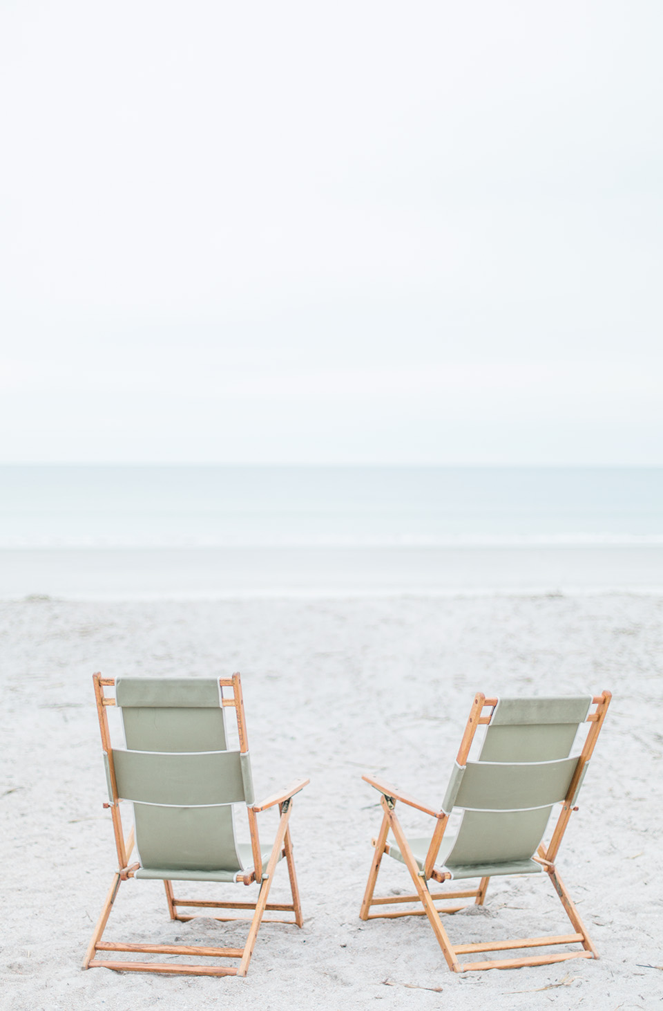 Picture of two beach chairs on white sand on the Atlantic coast at the Omni Amelia Island Plantation Resort.