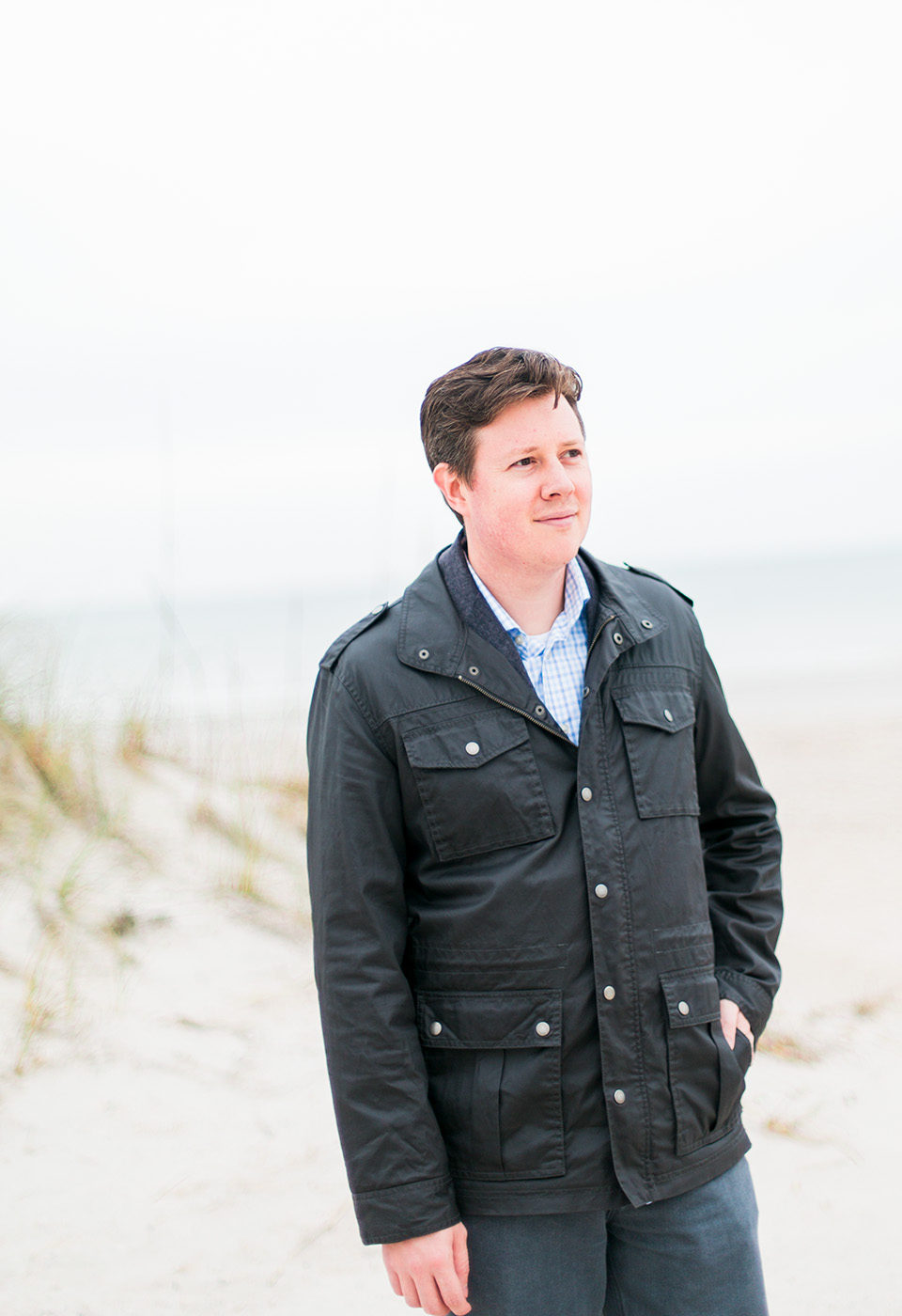 Image of a man on the beach with a black leather coat at the Omni Amelia Island Plantation Resort.