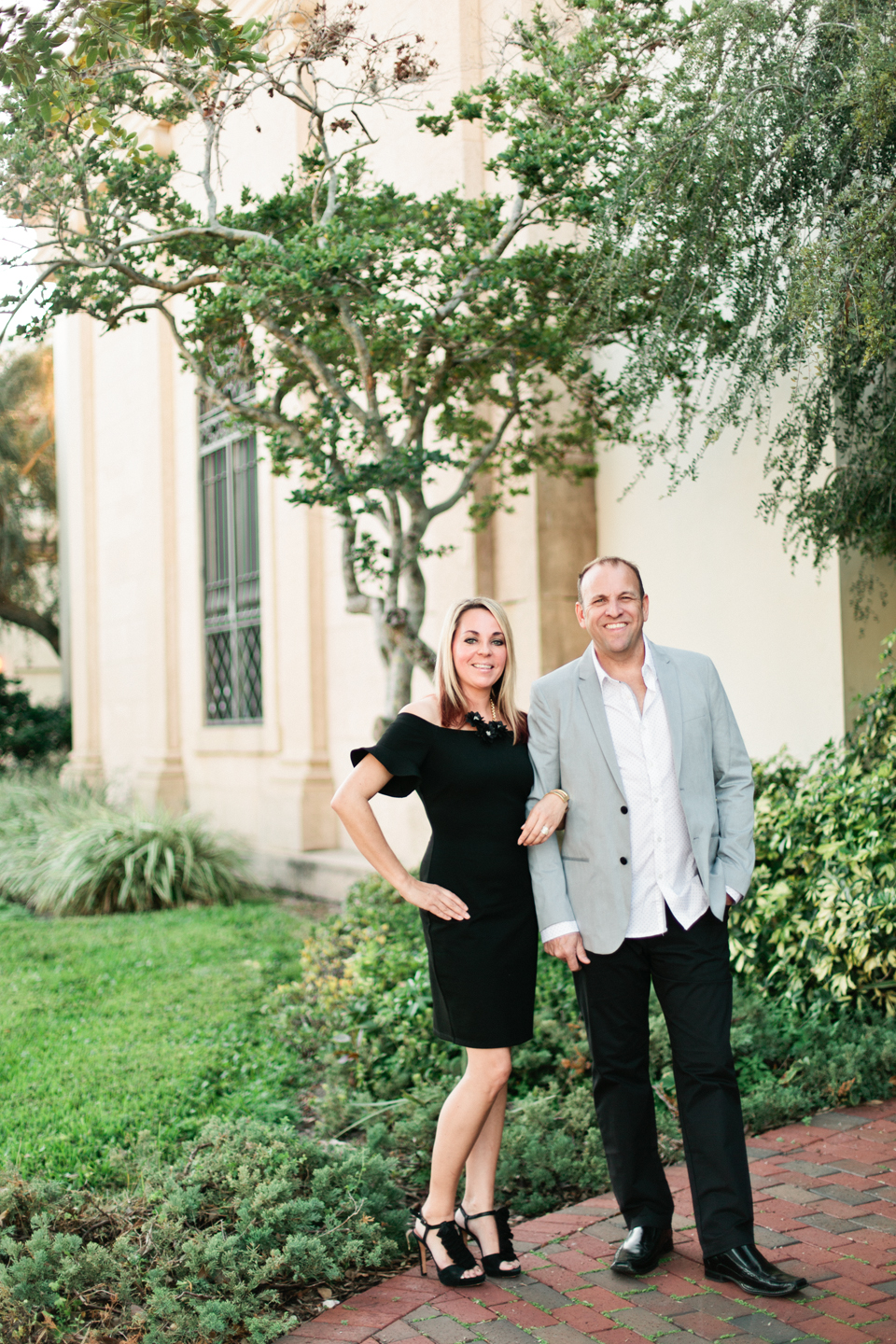 Picture of a couple standing behind the Museum of Fine Arts downtown St. Pete.  The woman is linking arms with the man.  