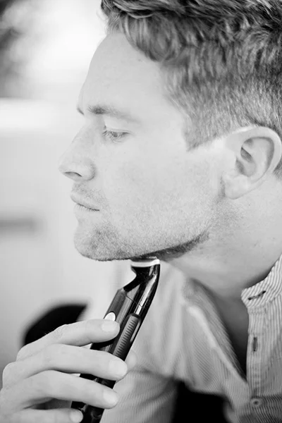 Picture of a man shaving his beard for his engagement portrait.  | Debra Eby Photography Co.