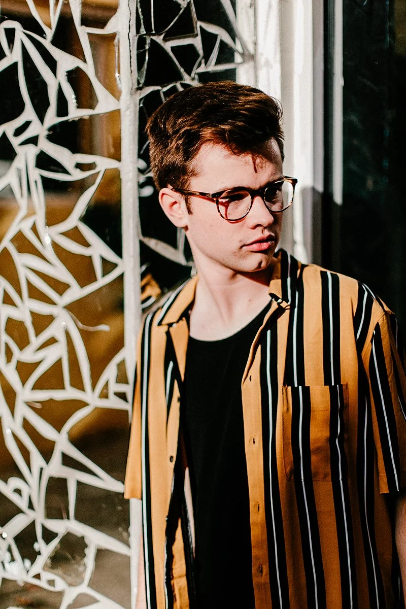 Senior boy photographed outdoors during an editorial portrait session
