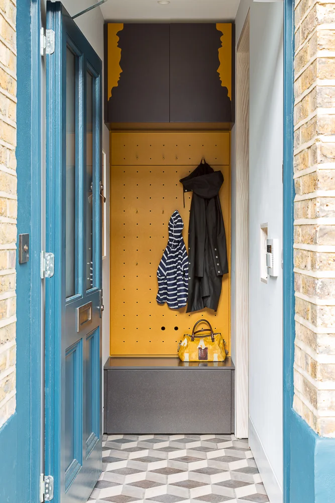 The original hallway would have gone straight ahead under the moulded heads, they are now recollected in the coloured joinery while one steps down to the right to enter the new open plan ground floor