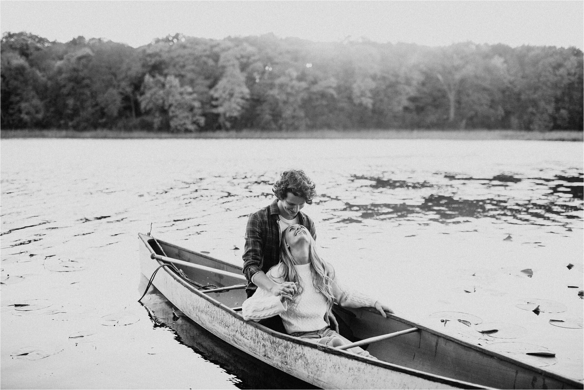  canoe outdoors engagement photos outside couple cuddling kissing laughing happy ali leigh 