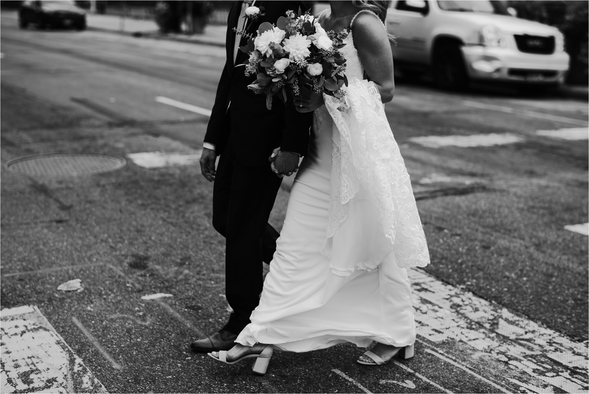  bride groom black and white photos wedding walking crosswalk urban city life photo 