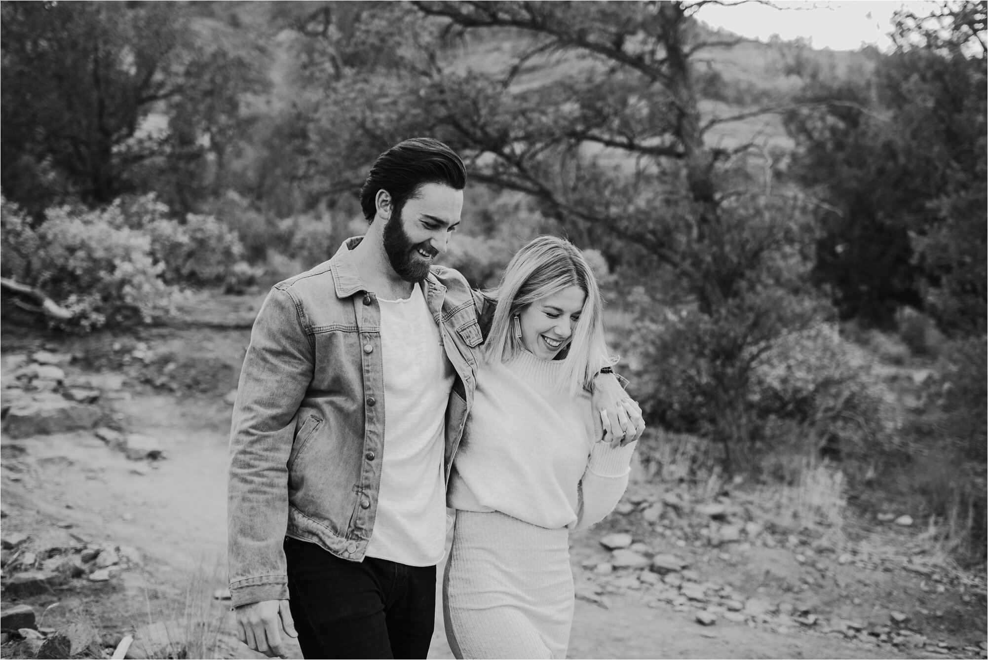  couple walking and holding hands on trail for their engagement session with ali leigh photo 
