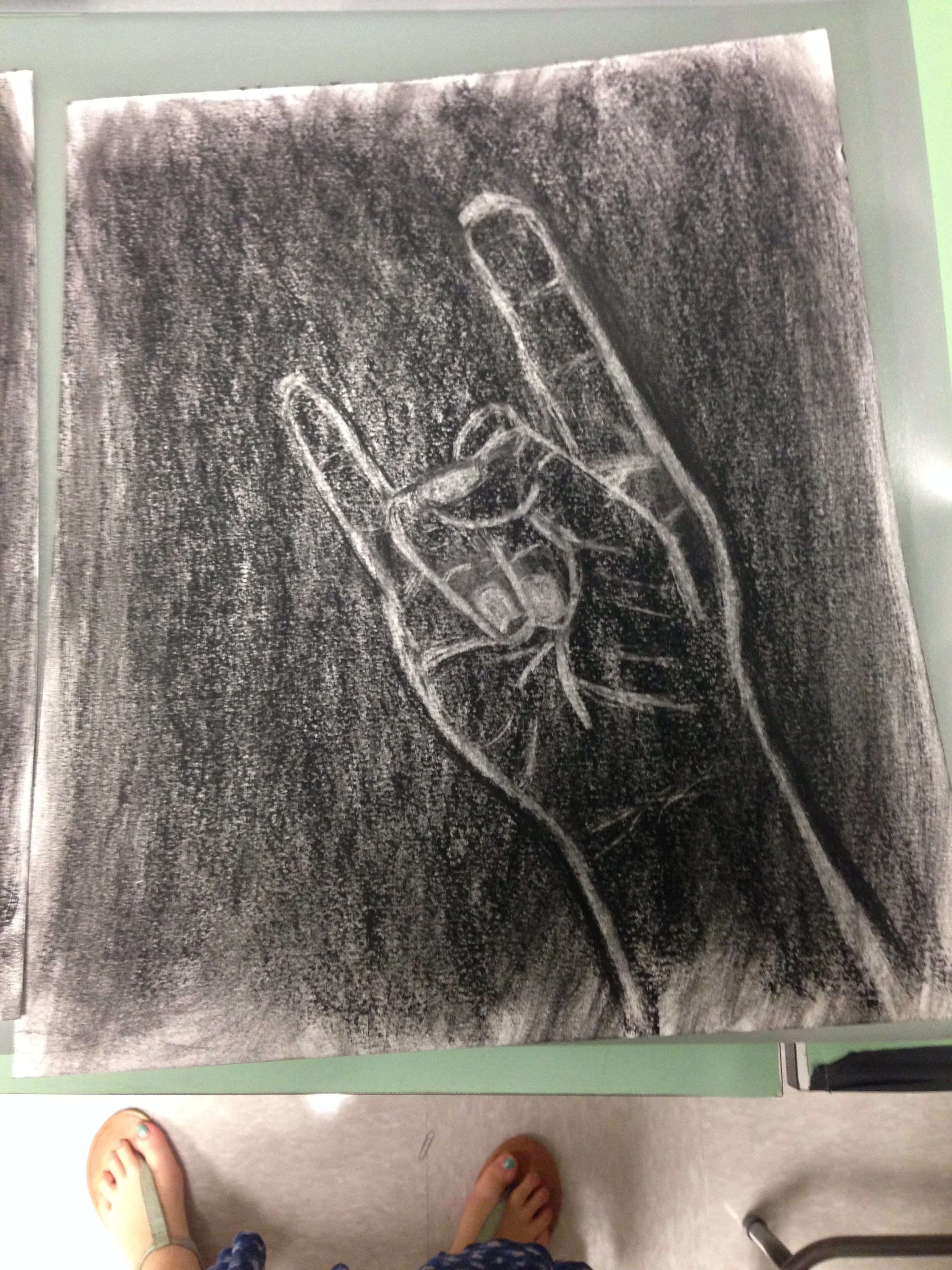 A sketch of a hand done using charcoal. 