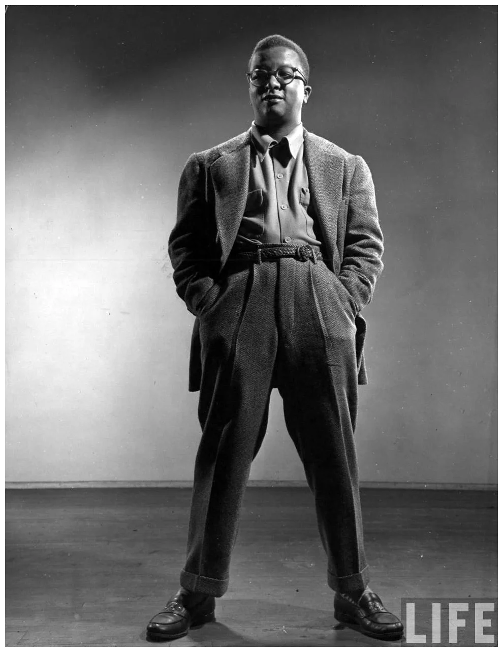 Billy Strayhorn standing tall in a wool suit with hands in his pockets. This photo was in Life Magazine sometime in the 40s.
