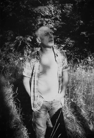 Charles Buel in shadows and grass