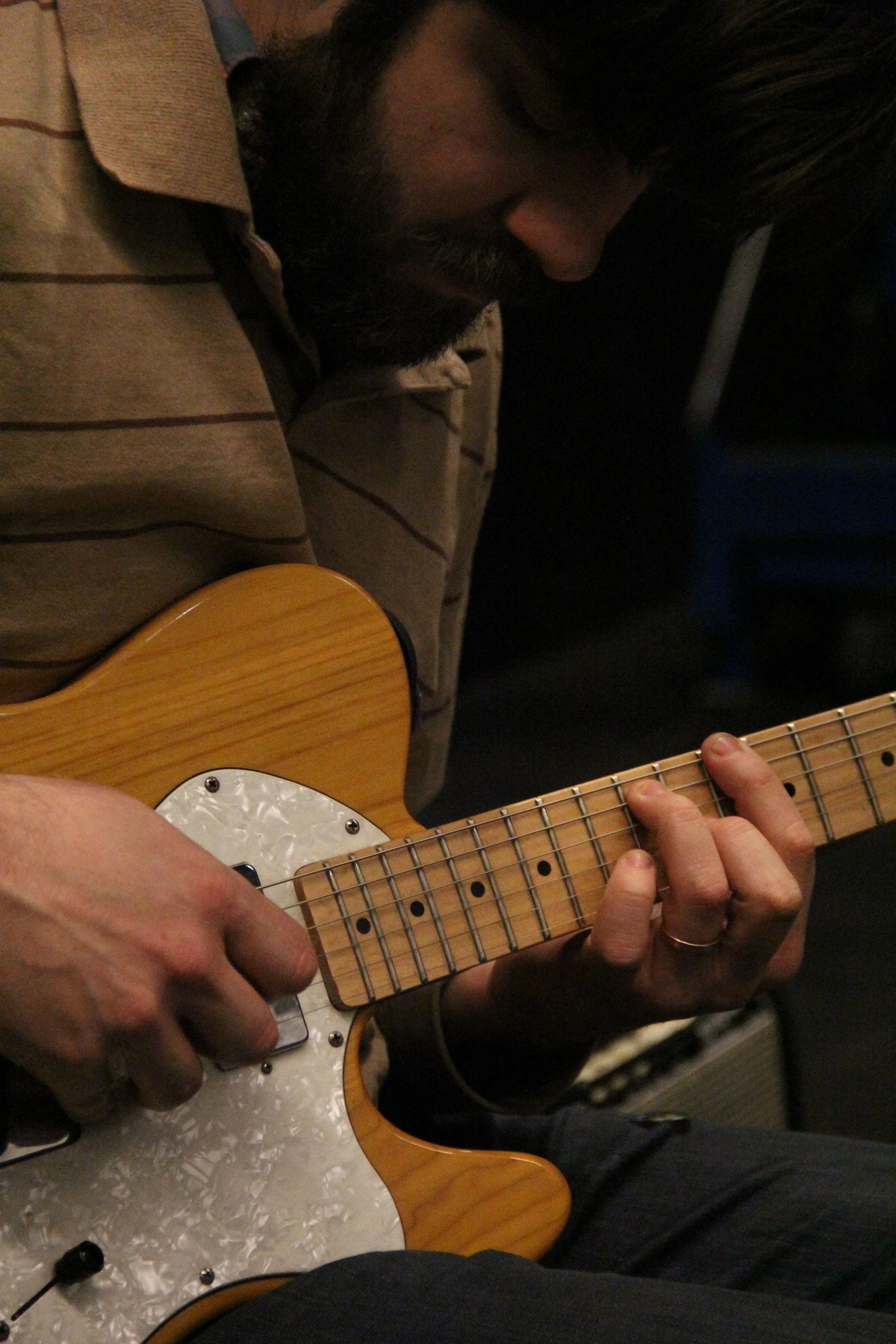 Musician Sam McCormally plays guitar during Meena's Dream. Photo by Q. Terah Jackson. 