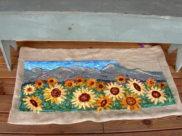 The color of the back porch bench is similar to the mountain range.