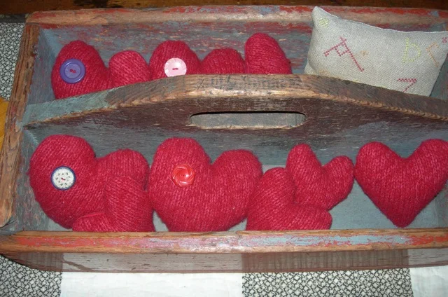I found a red wool sweater at a thrift shop, felted it, and made these puffy hearts.