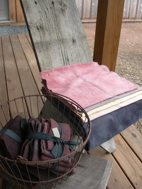 Here are the beautiful wools from Jan Cole, the Wool''n Gardener. The dark one on the chair is the "Dark and Stormy" half-yard that I won.